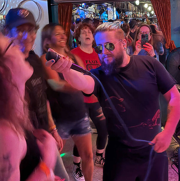 A person holding a mic for trivia answers