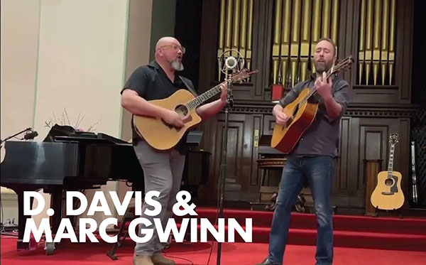 D. Davis and Marc Gwinn on stage play guitars