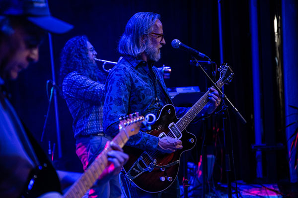 James Graham playing guitar on stage